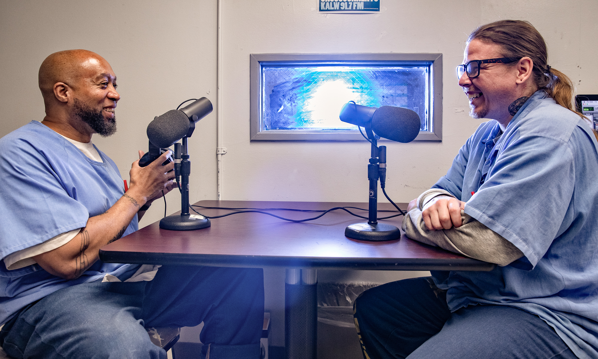 Electronic music production and DJ students smile behind mics at Kern Valley State Prison